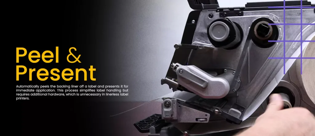 Close-up of a label printer demonstrating the peel-and-present feature. This mechanism automates label handling by removing the backing liner for immediate application, streamlining the labeling process