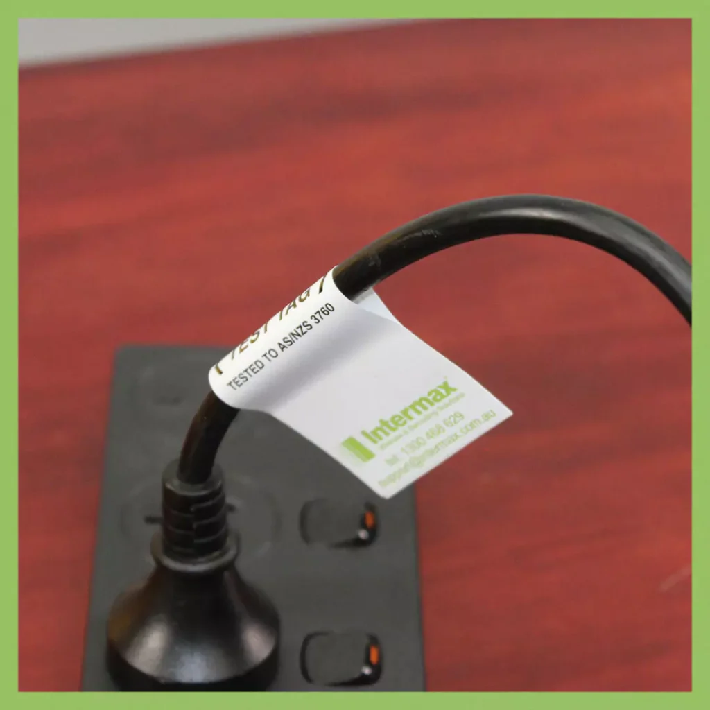 Test & Tag compliance label on a power cord, ensuring workplace electrical safety under AS/NZS 3760 standards.