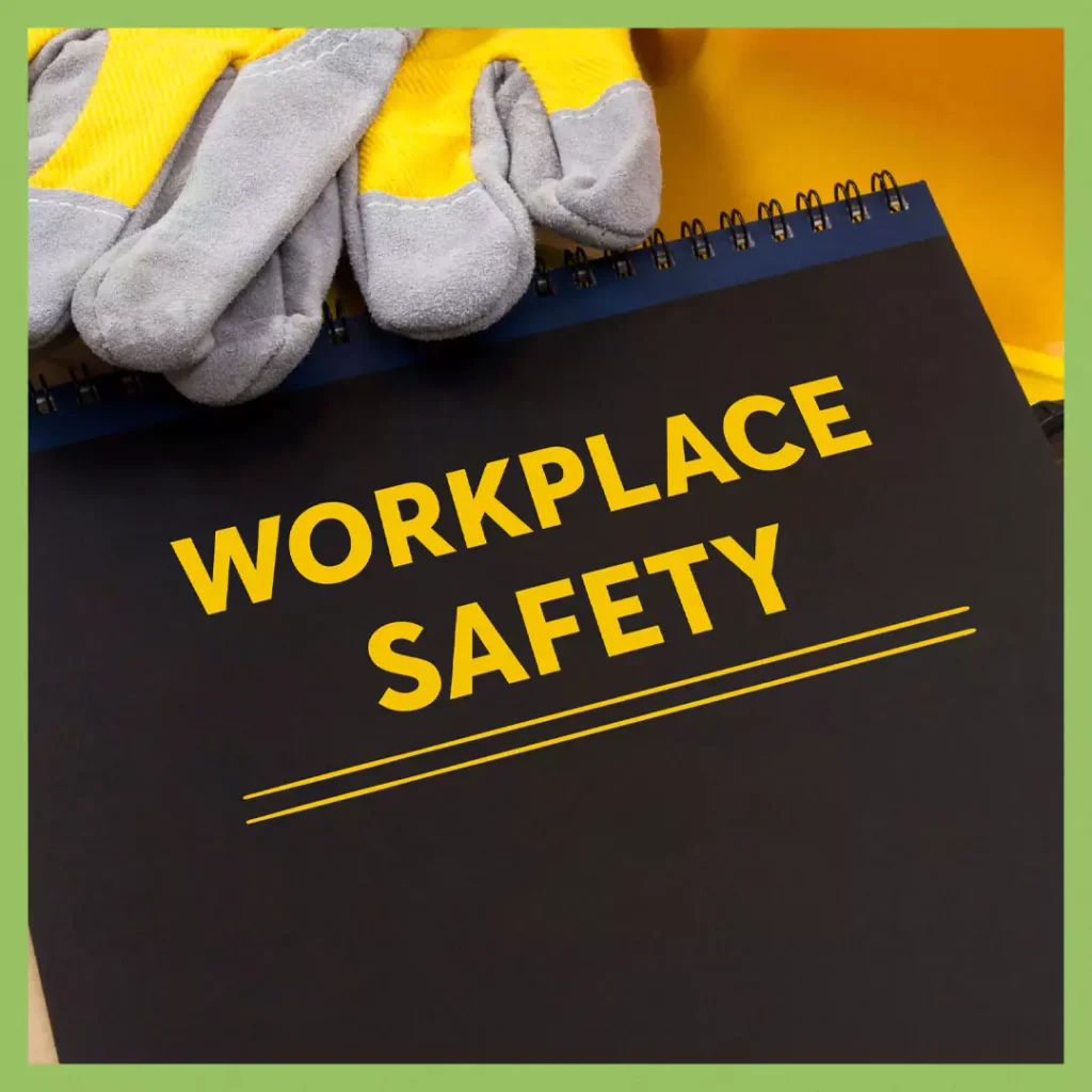 A black notebook with "Workplace Safety" written in bold yellow text, accompanied by protective work gloves, symbolizing electrical safety and compliance.