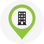 A green location pin with a building icon, representing industries with mandatory Test & Tag requirements in Australia.