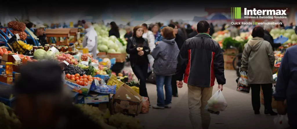 Busy market stall with fresh produce, showcasing the need for efficient barcode scanning solutions.