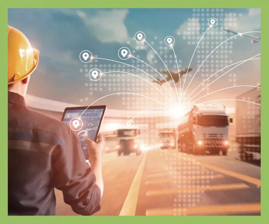 Worker using tablet to track fleet movement with IoT-enabled logistics dashboard and map overlay