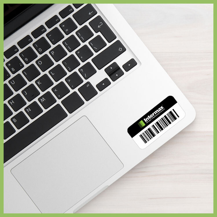 Asset label with barcode and Intermax branding applied to a company laptop for tracking.