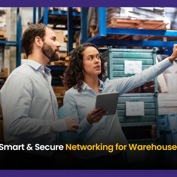 Two warehouse professionals discussing secure wireless network infrastructure with a tablet inside a logistics facility