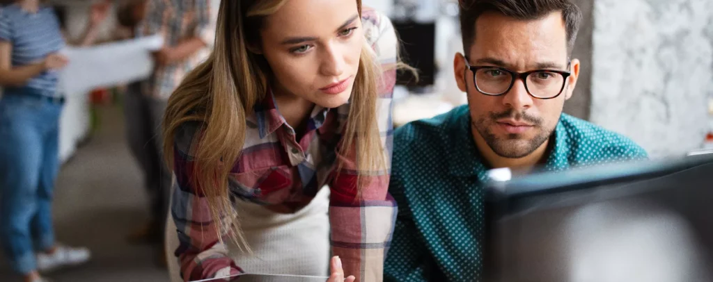 Business professionals reviewing cybersecurity audit results on computer to strengthen data protection and network security